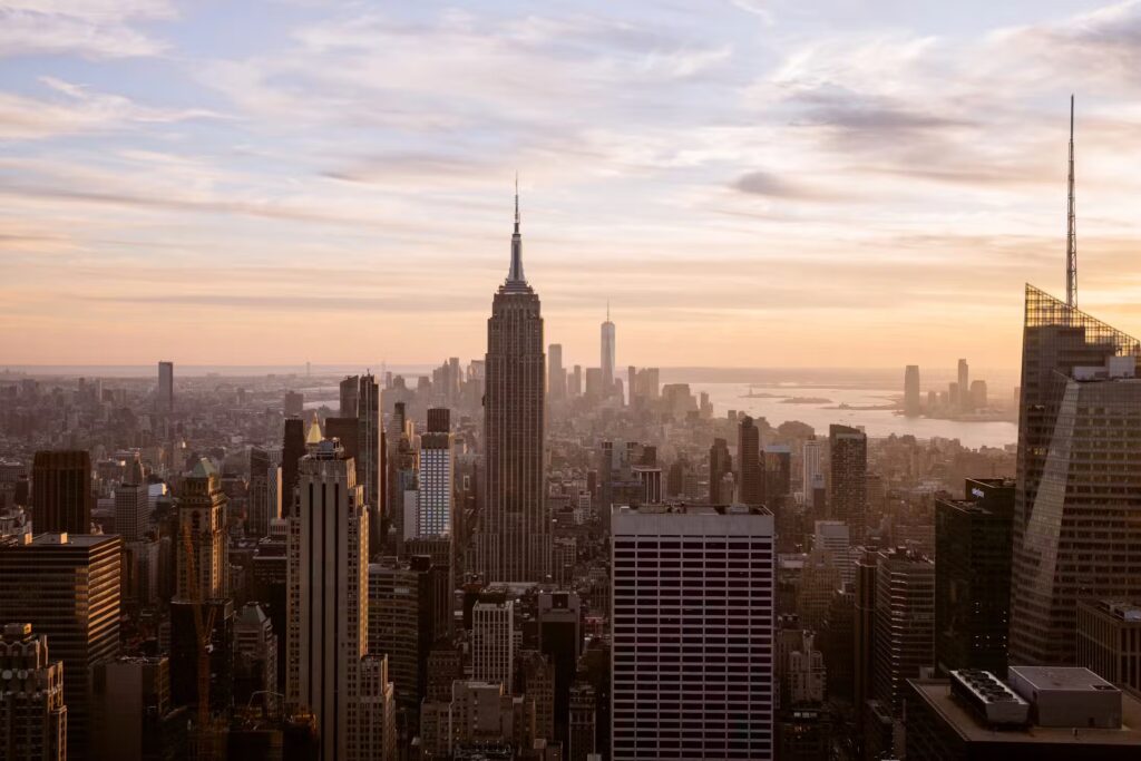 New York City skyline featuring the Empire State Building at sunset.